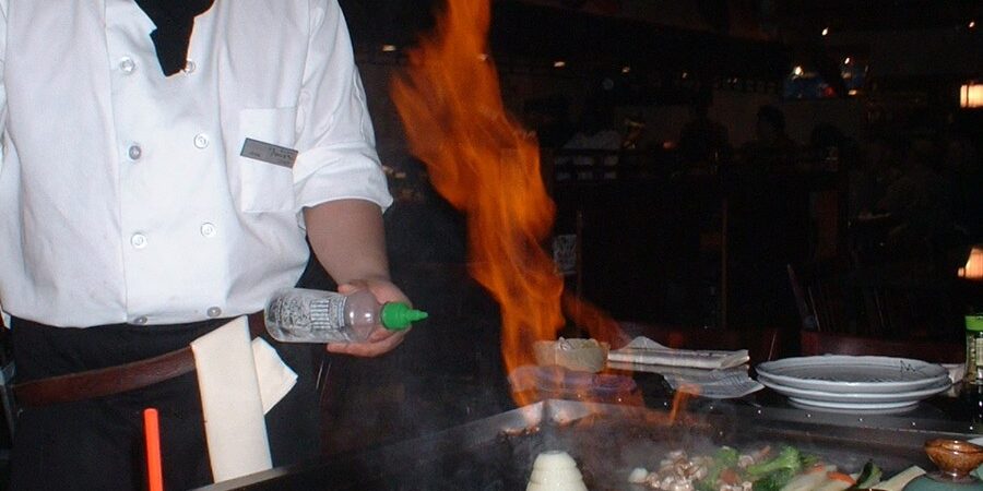 Flaming onion volcano show on a hibachi grill during a family hibachi dinner
