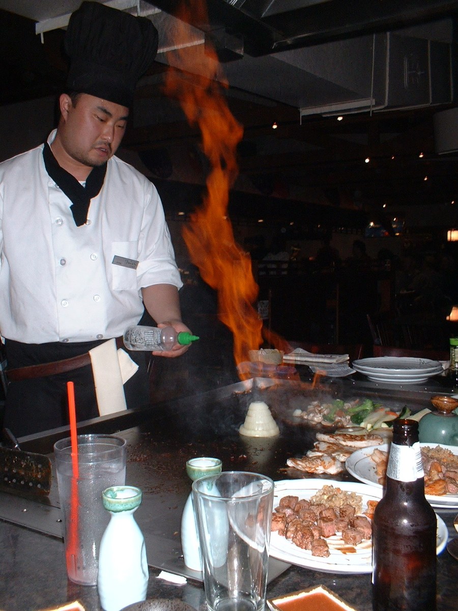 Flaming onion volcano show on a hibachi grill during a family hibachi dinner