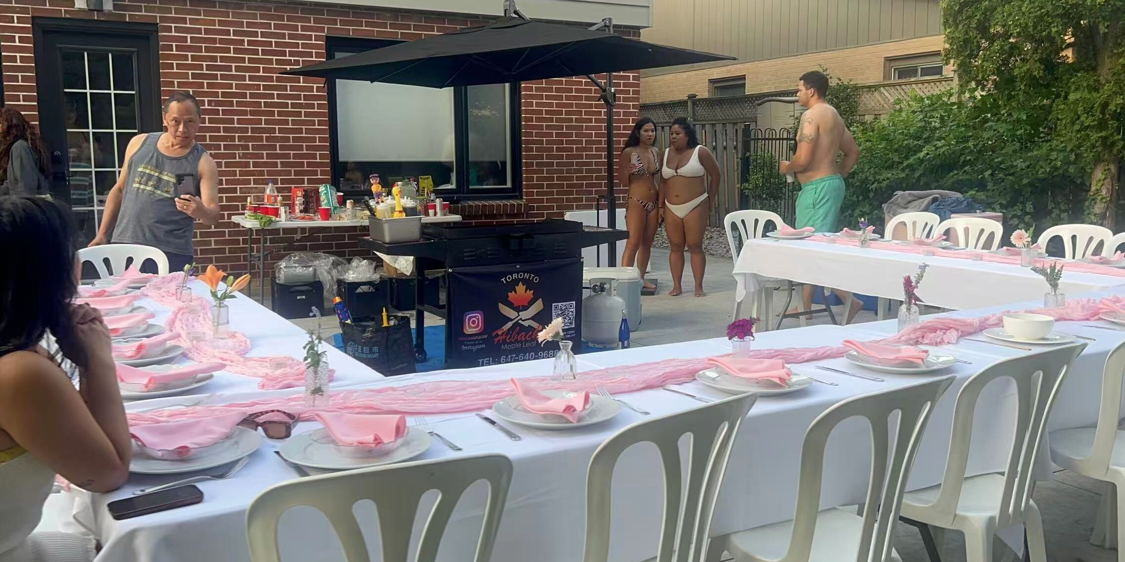 Hibachi chef grill station set up on an outdoor patio with L-shaped guest tables for a late-October Burlington catering dinner in the GTA
