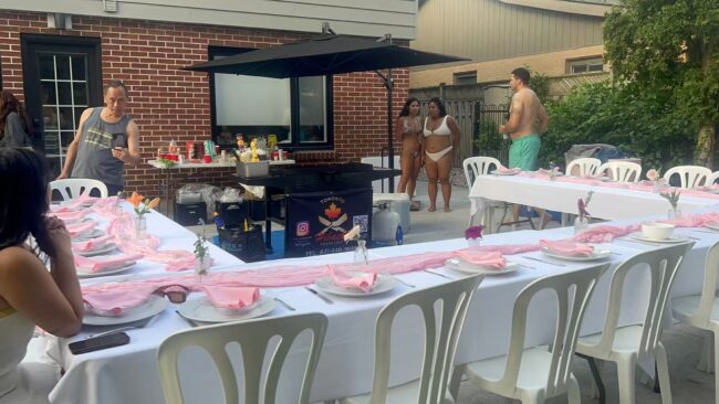 Hibachi chef grill station set up on an outdoor patio with L-shaped guest tables for a late-October Burlington catering dinner in the GTA